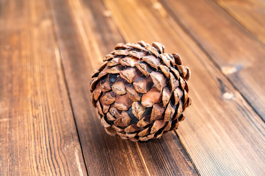 Christmas decoration of pine cone on wooden background