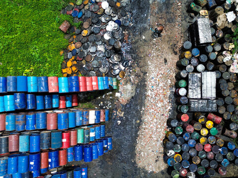 Aerial view of numerous colorful industrial barrels and waste materials arranged in a storage yard in Dhaka, Dhaka Division, Bangladesh.