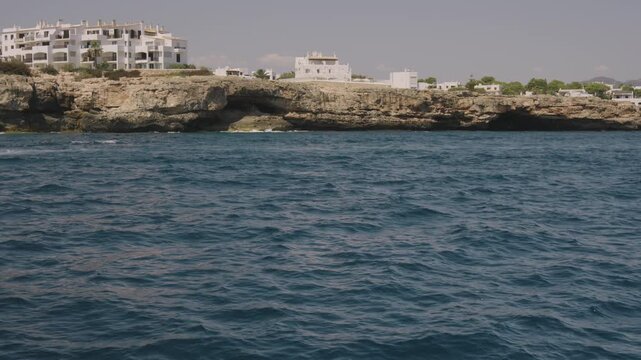 Boat cruise along the Mallorca coastline, yacht sailing past on the open water