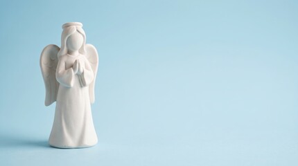 Fototapeta premium White angel figurine on blue