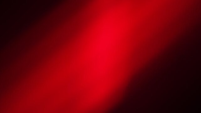 Abstract background featuring a soft gradient of deep crimson red light