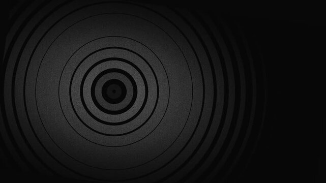 Minimalist dark background featuring concentric circles in monochromatic grey