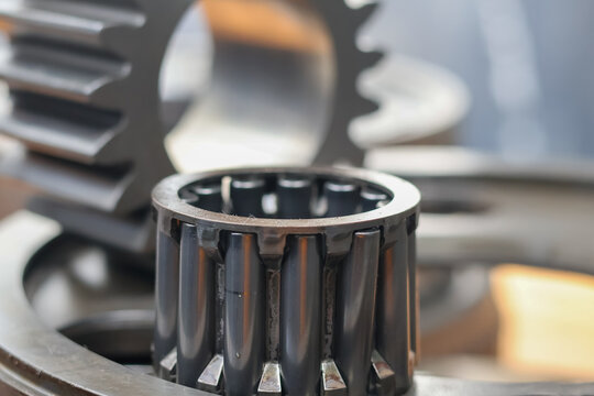 Close-Up of Cylindrical Needle Roller Bearing Cage Assembly with Industrial Spur Gear.