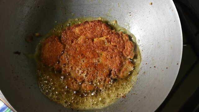 Rohu fish eggs are a delicacy in Bengali and Indian cuisine, often prepared as fritters with onions, green chilies, turmeric, and gram flour. Rohu fish eggs, or roe, are fried in a pan..