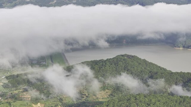 Aerial drone view of Don Duong Lake from Dran Pass, surrounded by green mountains and valleys in D'Ran, Lam Dong Province, Vietnam.