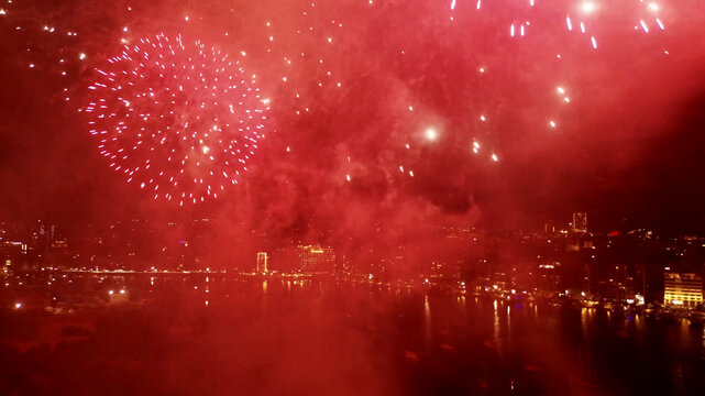 Aerial view of vibrant fireworks illuminating the night sky over the coastal city of Sliema, Eastern Region, Malta.