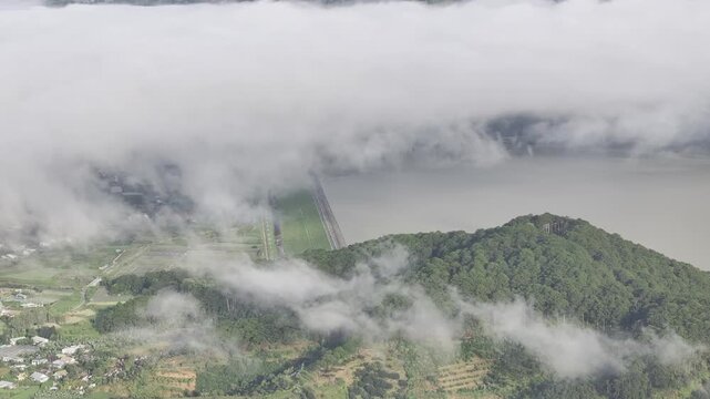 Aerial drone view of Don Duong Lake from Dran Pass, surrounded by green mountains and valleys in D'Ran, Lam Dong Province, Vietnam.