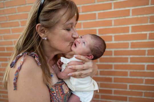 Grandparent kissing grandchild showing love and family bond