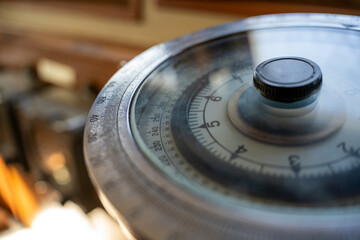 Close up of vintage nautical gyrocompass navigation instrument with circular degree scale dial on ship bridge indoors. © Marina