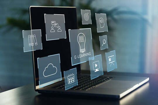 E learning tools appear on a laptop screen showing icons related to online education and technology