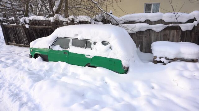 Car covered with thick snow on a winter day
