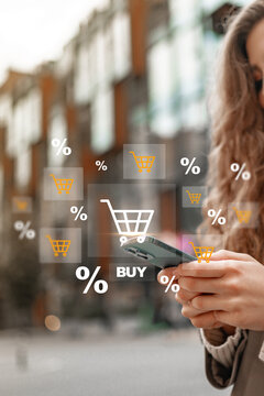 Online shopping on a mobile phone with shopping carts and buy icons overlay