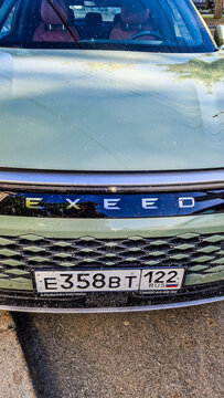 Front view of an Exeed electric SUV with the Exeed logo and a Russian license plate in Barnaul; modern Chinese crossover, Altai region, Siberia, Russia 25.05.2025