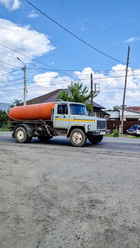 Grey GAZ-3307 tanker truck from the 1990s driving on a road in Biysk, a classic Russian truck for specialized transport, Altai Region, Siberia, Russia 26.05.2025