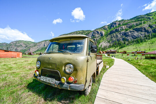 Green UAZ-3303 Bukhanka 4WD flatbed truck with Russian license plates in the mountain Aktash against the backdrop of the Altai Mountains; a classic Soviet off-road vehicle, Altai Republic 30.05.25