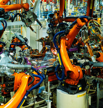 Industrial Robots Welding Car Body in Automotive Manufacturing Factory

