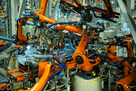 Industrial Robots Welding Car Body in Automotive Manufacturing Factory

