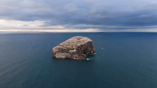 Aerial view of Bass Rock, a volcanic island with a lighthouse and steep cliffs surrounded by the North Sea in Scotland, United Kingdom.