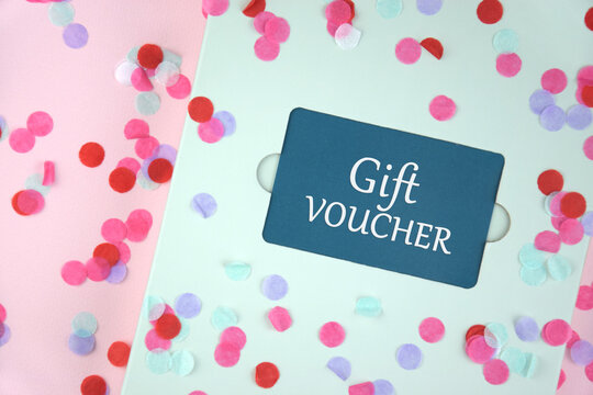 Gift voucher in a green envelope on a light background