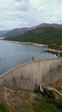 Vertical aerial drone footage of Vilarinho das Furnas dam and reservoir in Peneda-Geres National Park, Portugal