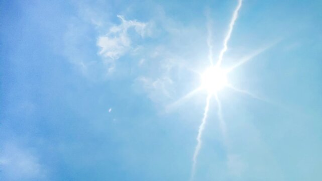 blue sky background and shining sun. Heat wave concept. Extreme weather. Global warming effects