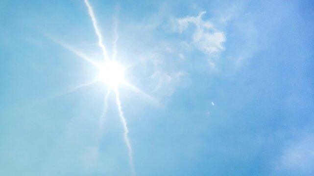 blue sky background and shining sun. Heat wave concept. Extreme weather. Global warming effects
