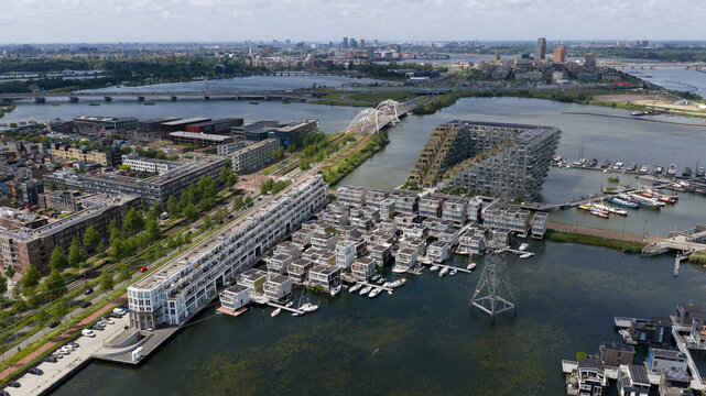 Aerial view of the Sluishuis building in IJburg with its unique geometric design surrounded by modern floating houses and waterways in Amsterdam, North Holland, Netherlands.