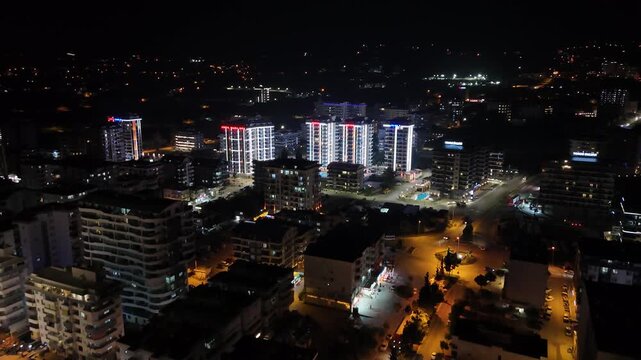 Aerial drone view of Alanya, Turkey at night, featuring the illuminated Mediterranean coastline, city lights, beachfront, urban landscape and night resort atmosphere.
Night aerial view of Alanya on th