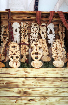 Display of carved wooden spoons with ornate floral and geometric patterns. Traditional folk craftsmanship highlighting artistry, cultural heritage, and decorative woodworking