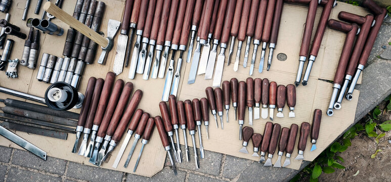 Assortment of chisels and carving tools for woodworking. Various shapes and sizes neatly arranged, highlighting craftsmanship, precision, and artisan equipment for sale