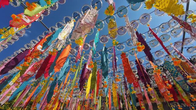 Tung or traditional buddhish flags in the Yee Peng Festival decorate around Lumphun downtown, Thailand.