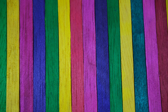 Colorful wooden sticks arranged in a row, suitable for backgrounds