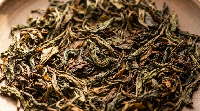 Dried Green Tea Leaves: A close-up view of premium dried green tea leaves, showcasing their intricate texture and earthy aroma. Perfect for beverage or culinary use.