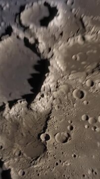Vertical video: Opening cam zooming over pitted moon to terminator and limb, showing pits and stars