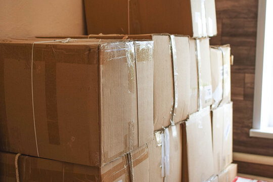 Stack of sealed cardboard moving boxes prepared for relocation, illustrating packing, household storage, transportation logistics and moving preparation