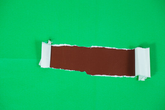 Torn paper with space for text on a brown background. The green torn paper peels away to reveal the brown paper underneath.
