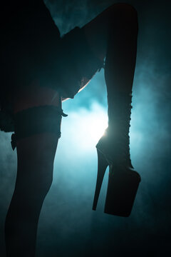 Woman's legs in platform boots on stage.