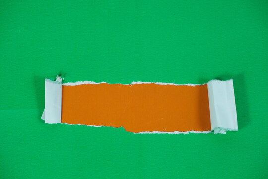 Torn paper with space for text against an orange background. The torn green paper peels back, revealing the orange paper underneath.
