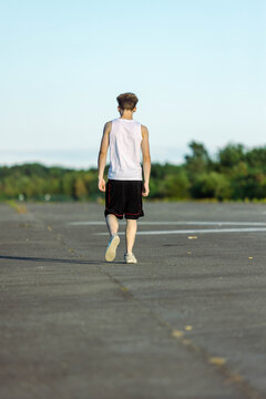 Teeange Boy In A Sleeveless Top And Shorts