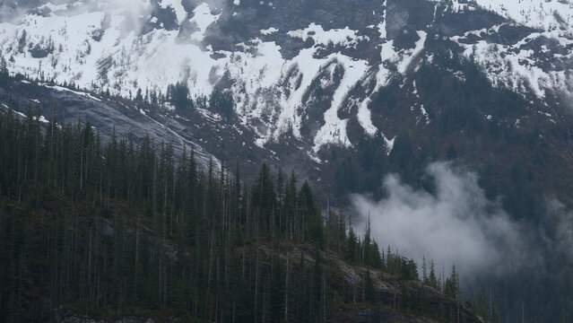 Breathtaking Alaska mountain glacier range view seen from outdoor deck of cruise ship liner sailing the Inside Passage transit with spectacular landscape wilderness scenery
