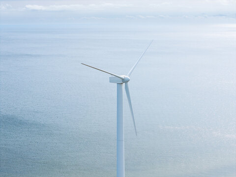 Aerial view of a wind turbine standing in the sea, illustrating the shift toward renewable energy in Mersrags, Talsi Municipality, Latvia.