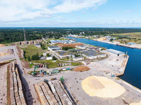 Aerial view of timber commodity stockpiles and wood processing facilities at a Baltic port in Mersrags, Talsi Municipality, Latvia.