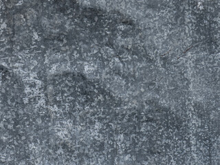 Fototapeta premium Weathered galvanized steel sheet showing worn metallic pattern with natural daylight