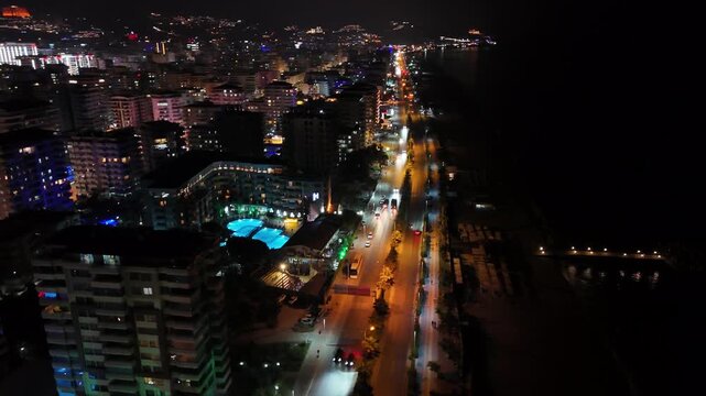Aerial drone view of Alanya, Turkey at night, featuring the illuminated Mediterranean coastline, city lights, beachfront, urban landscape and night resort atmosphere.
Night aerial view of Alanya on th