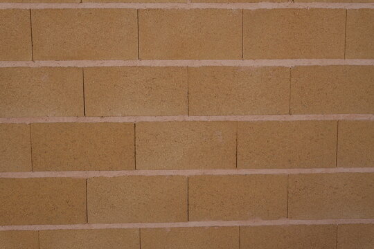 Ochre brick wall texture with horizontal mortar joints
