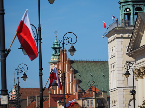 Street lamps and church towers in the background