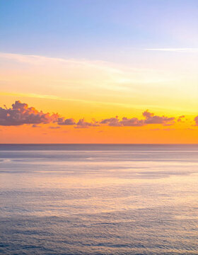 Sunset ocean horizon with glowing cloud and calm water creating serene coastal landscape for travel, nature, tranquility, and scenic background imagery