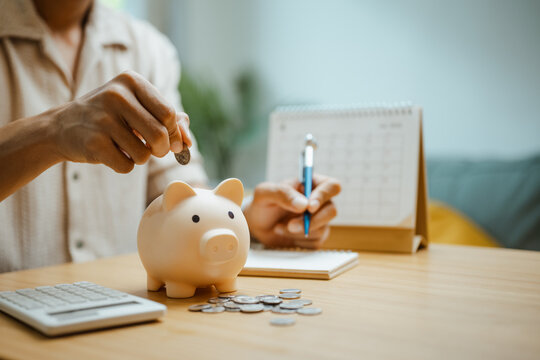 Savings scene combines a piggy bank, coins, calculator, and calendar, representing financial planning, money discipline, and investment timing for commercial use. Piggy bank, saving; piggy focus.