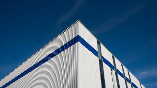 Low Angle View of Industrial Building Facade Against Blue Sky