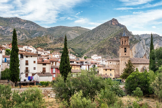 The church and village of Arnedillo in the Rioja region of Spain famous for it's thermal baths with mountains behind
